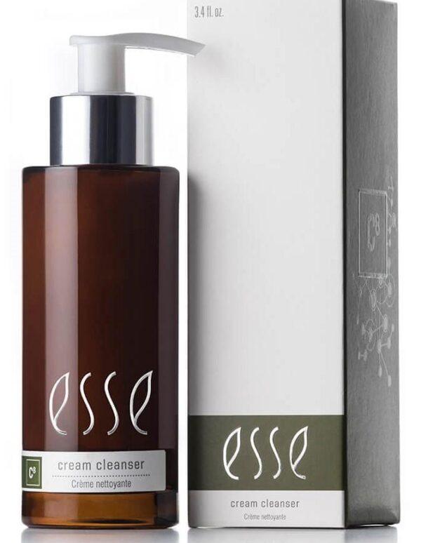 A brown pump bottle labeled "Esse Cream Cleanser" is placed next to its matching white and green box. Both the bottle and the box feature the same "Esse" branding, clearly indicating that the product inside is a cream cleanser.