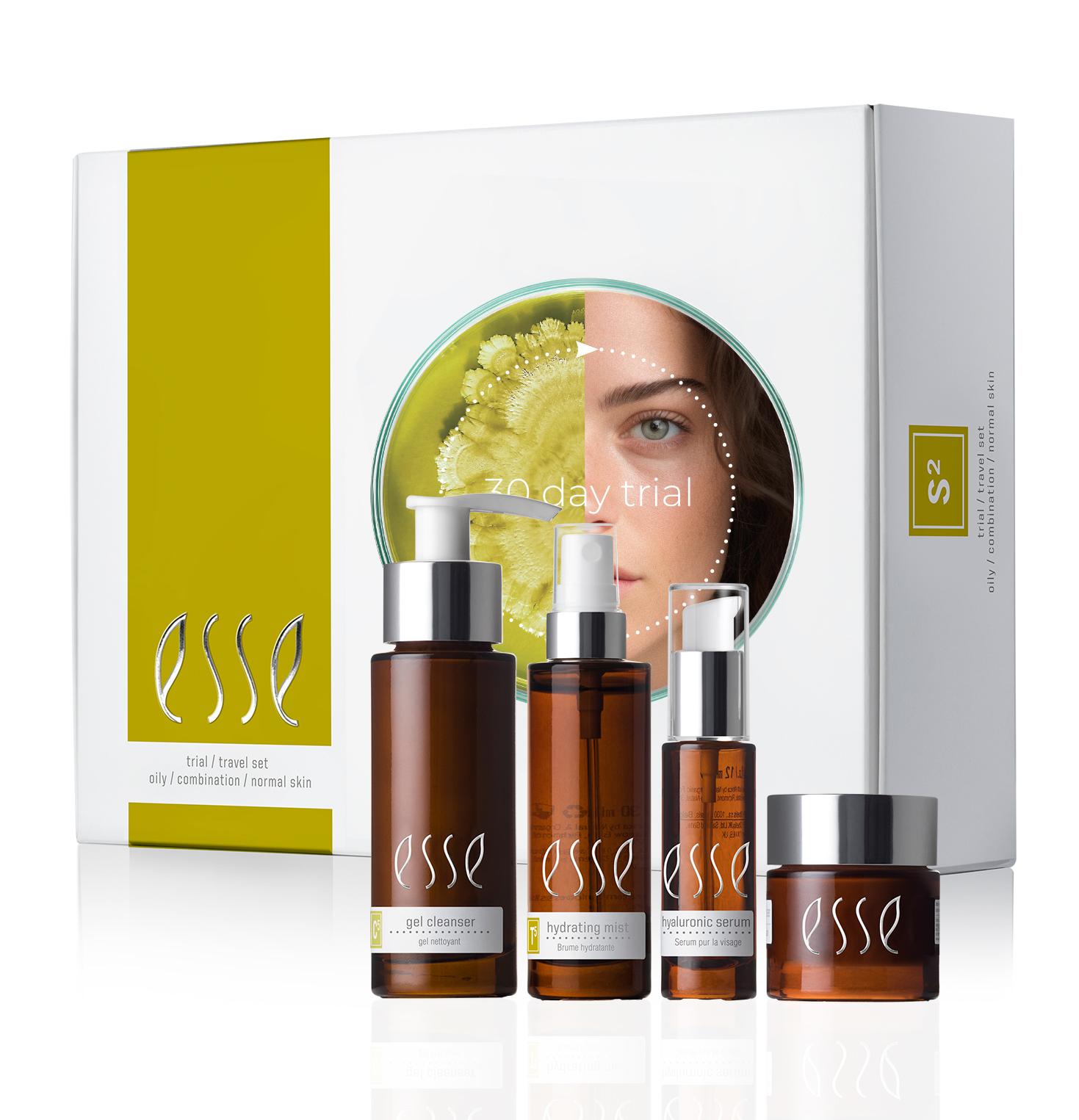 The Esse Oily / Combination / Normal Trial / Travel Set features four brown bottles with white text and pumps, housed in a white and green box displaying an image of a woman partially obscured behind a leaf. This skincare set includes a gel cleanser, hydrating serum, and hyaluronic serum.