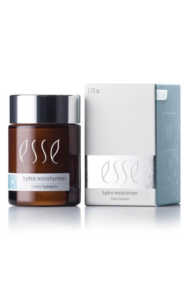 A brown jar of Esse Hydro Moisturiser, featuring a white and light blue label and a silver lid, is positioned next to its white and light blue packaging box. The box displays 1.7 fl. oz. along with product information.
