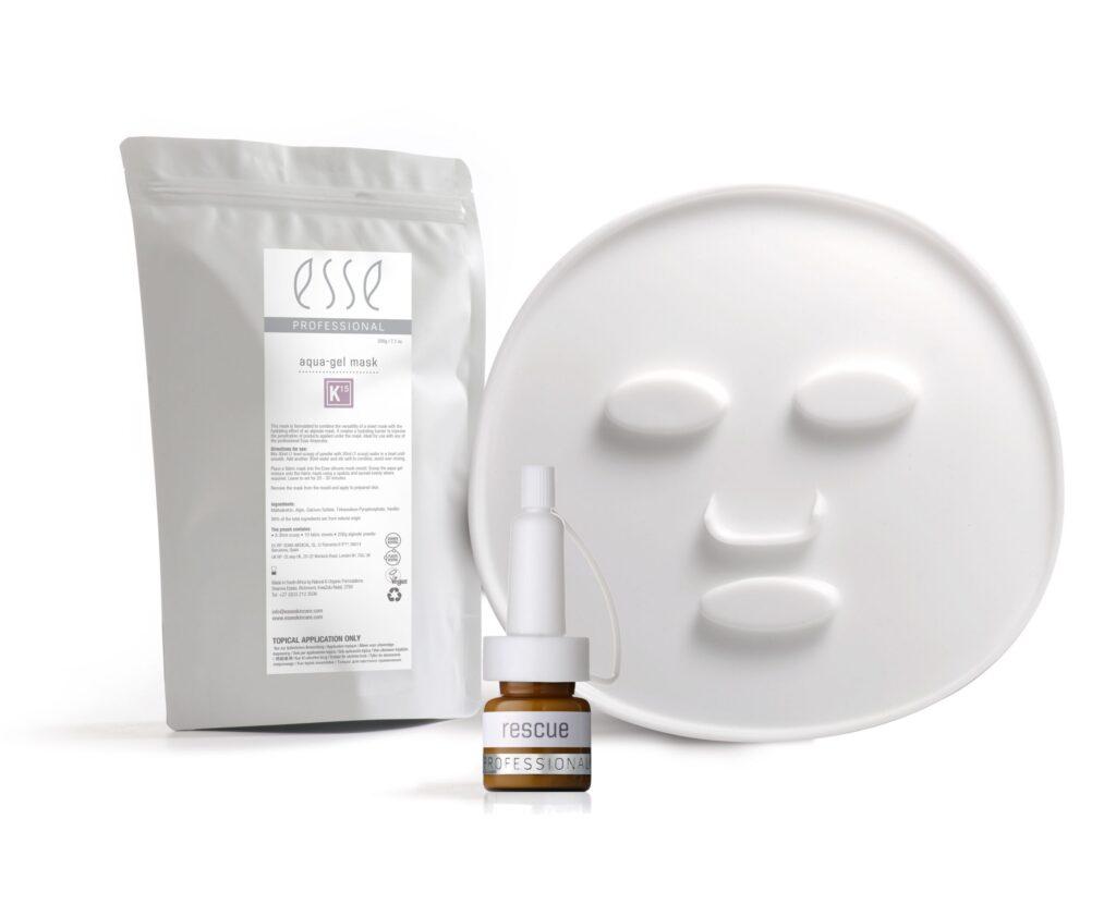 White sachet labeled "esse Professional Aqua Gel Mask" next to a round, white face-shaped mask and a small dropper bottle labeled "rescue PROFESSIONAL." The products are set against a plain white background.